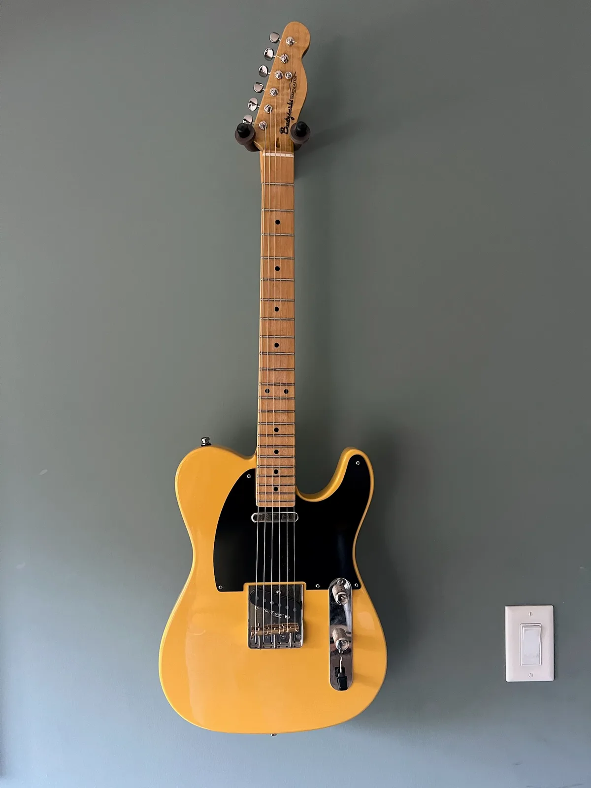 Hand-carved guitar body detail showing wood grain